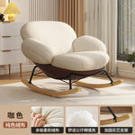 fauteuil bascule moderne beige noir orange roulettes coussin repos minimaliste salon