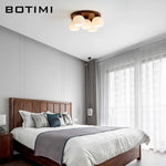 lampe moderne bois blanc abat jour verre motifs plissés éclairage chambre coucher