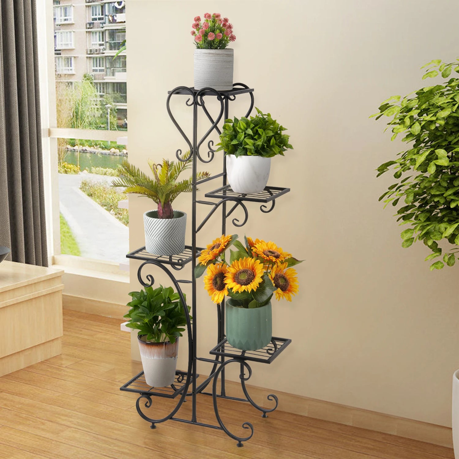 Étagère à plantes noire avec pots de fleurs sur un balcon