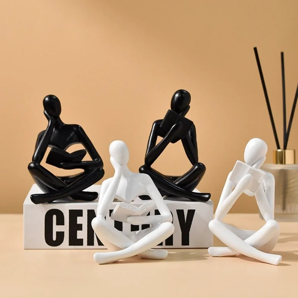 figurine deco moderne or noir blanc personne assise livre socle chambre abstraction minimalisme