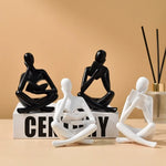 figurine deco moderne or noir blanc personne assise livre socle chambre abstraction minimalisme