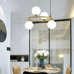 suspension luminaire moderne sphères verre translucides anneau métal doré salon chambre scandinave