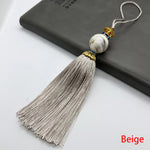 pompon décoratif gris bleu doré vert violet tissu finement tressé élégant moderne blanche chaîne