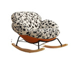 fauteuil bascule moderne beige noir orange roulettes coussin repos minimaliste salon