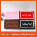 tapis d'entrée moderne rouge rose marron noir motif géométrique texturé animal nature
