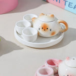 théière forme chat blanc orange rose visage mignon oreilles pointues taches oranges decorative cartoonish