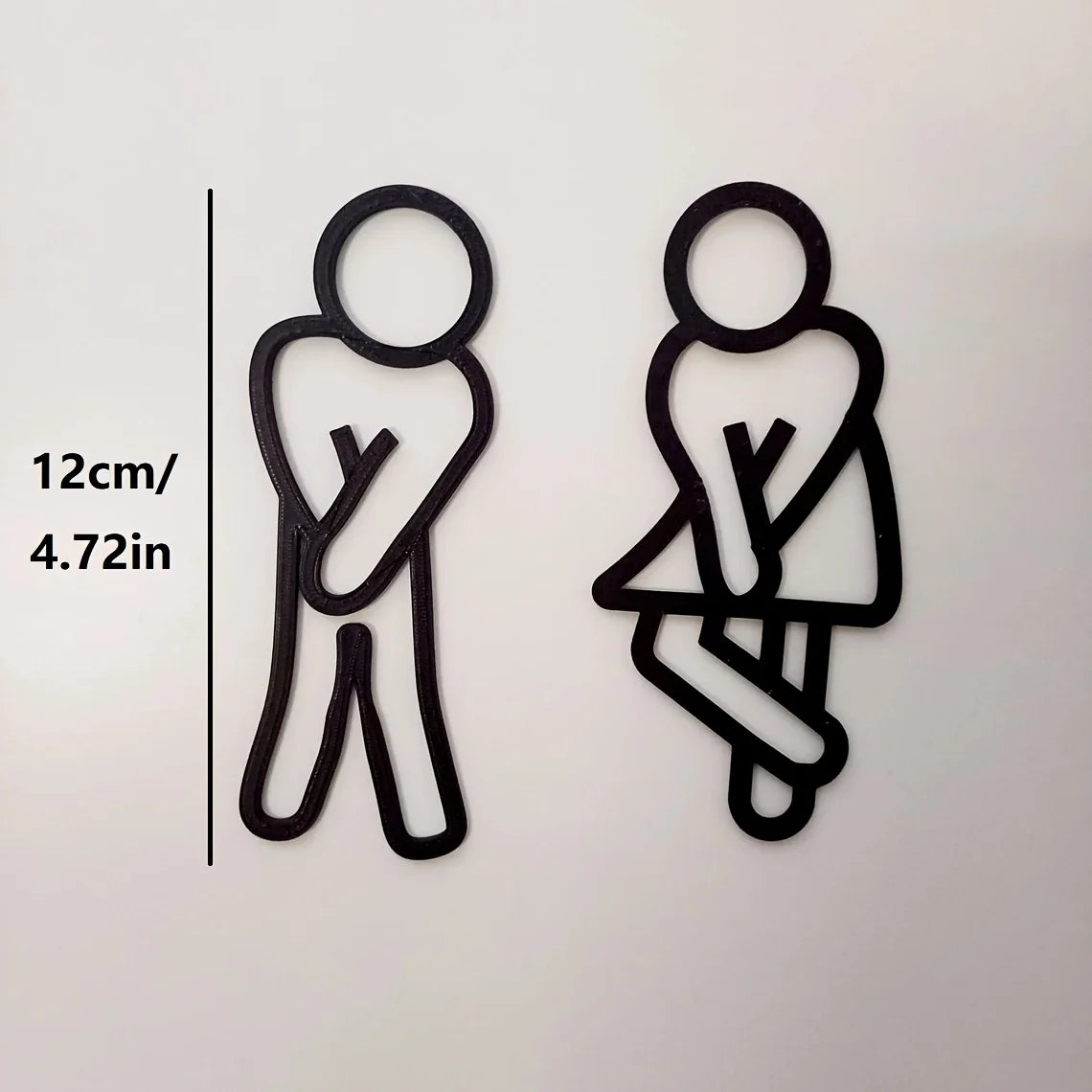 signalisation toilettes homme femme pictogrammes relief surface mate noir blanc minimaliste humoristique sans électricité