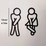 signalisation toilettes homme femme pictogrammes relief surface mate noir blanc minimaliste humoristique sans électricité