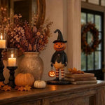 figurine citrouille halloween orange chapeau robe noire bas sculptée décoration intérieure festive