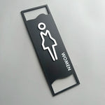 signalisation toilettes moderne symboles homme femme texte TOILET bois brun clair blanc tringle noire