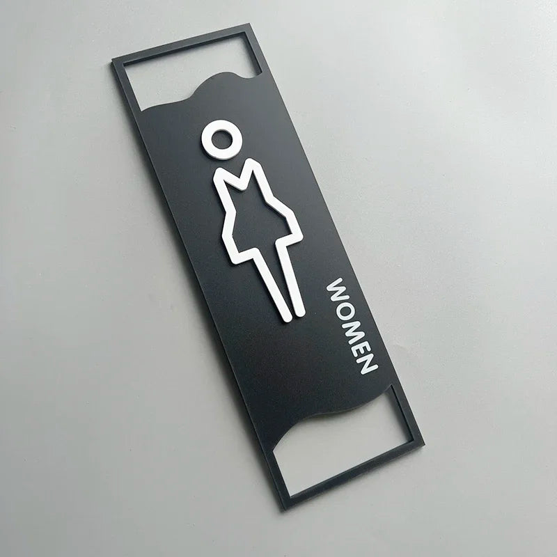 signalisation toilettes moderne symboles homme femme texte TOILET bois brun clair blanc tringle noire