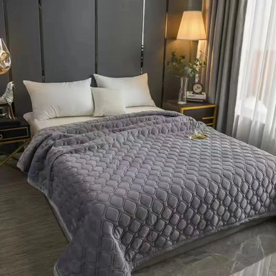 Couvre-lit matelassé en velours doux bleu sur un lit king size