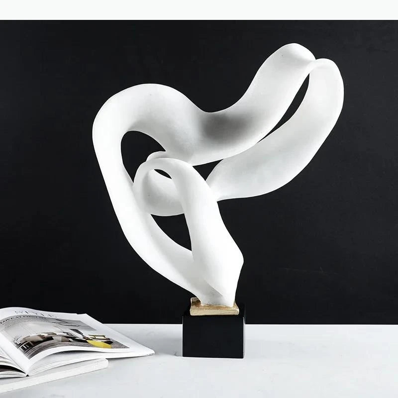 sculpture moderne abstraite forme fluide bronze blanc minimaliste intérieur contemporain aspect organique ondulé socle