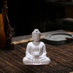 statue bouddha zen blanc gris bois décoratif assiette cigarettes tapis fibres naturellements éléments divers