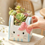 cache pot résine forme chat blanc bleu rose yeux noirs narines roses sourcils noirs