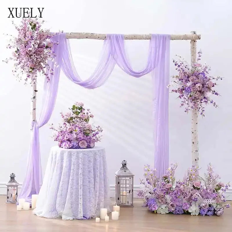 arche mariage fleurs artificielles tissu translucide blanc violet décor romantique extérieur événement table centreDecoration