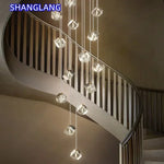 suspension lumineuse moderne transparente dorée facettes géométriques élégantes multiples lampes