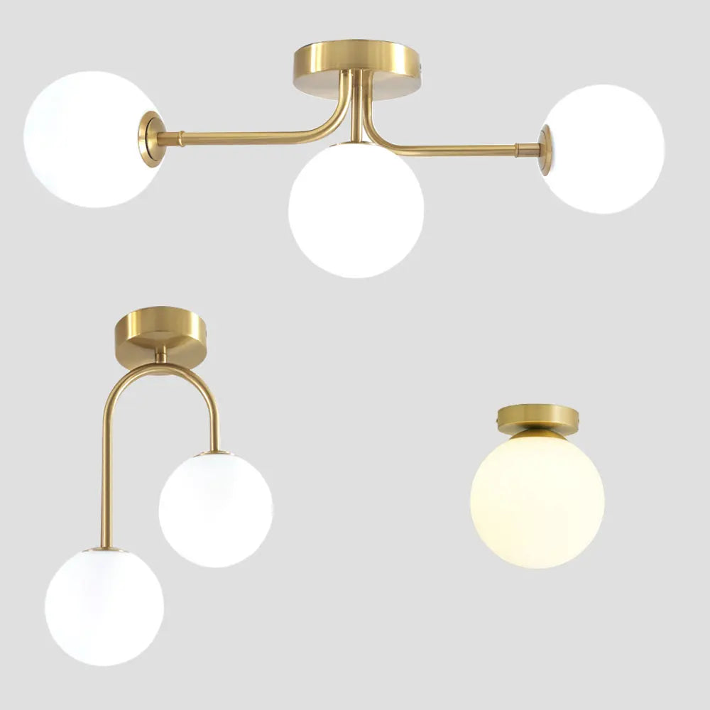 lampe suspension moderne or blanc sphères translucides structure métallique minimaliste