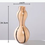 vases modernes translucides opaques motifs tourbillonnaires branches fleurs artificielles marron orange beige