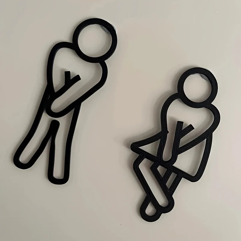 signalisation toilettes homme femme pictogrammes relief surface mate noir blanc minimaliste humoristique sans électricité