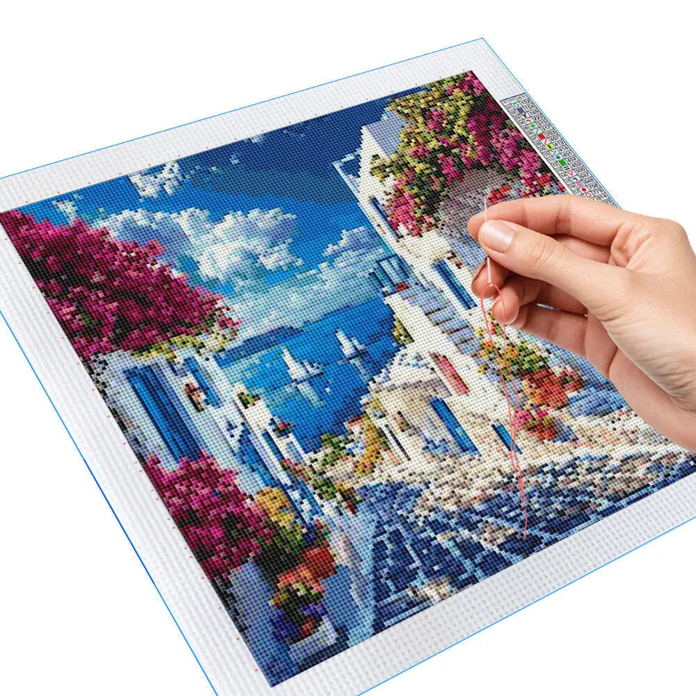 broderie paysage marin maisons blanches fleurs ciel bleu nuages artisanal traditionnel aiguilles fils instructions