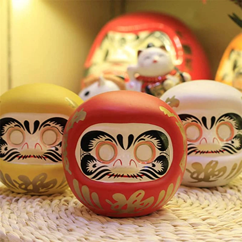 décoration table céramique daruma dolls visage stylisé motifs floraux traditionnel japonais couleur rose bleu