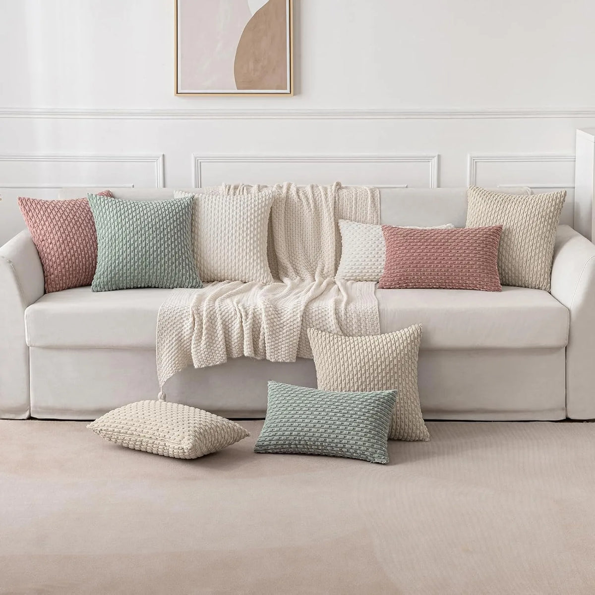 coussins carrés vert clair beige rose pâle texture tissée pompons moderne fermeture glissière