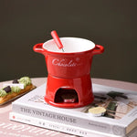 fondue chocolat moderne tasses lait rouge noir blanc cuillère bougie