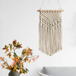 tapisserie macramé bohème beige clair motifs géométriques franges opaques décorative art murale
