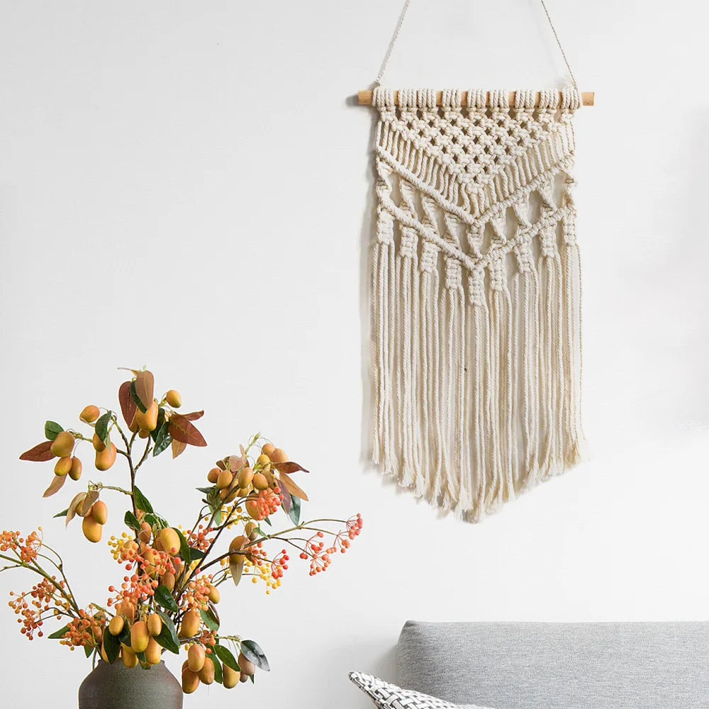 tapisserie macramé bohème beige clair motifs géométriques franges opaques décorative art murale