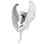 statue ange blanc accroupi ailes plumes texture lisse jardin intérieur décoratif artistique