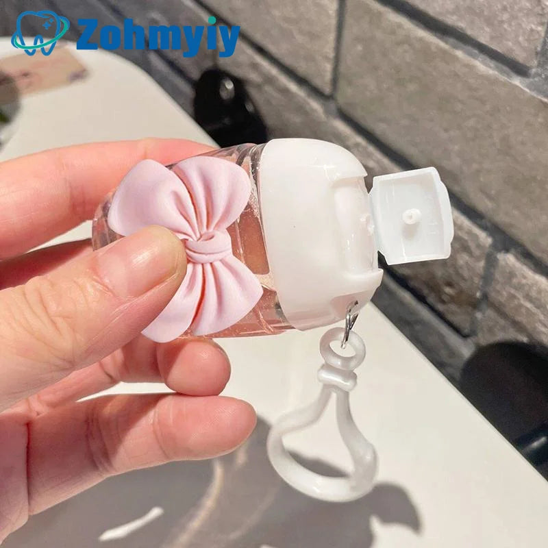 flacon gel hydroalcoolique transparent rose ruban noeud clip moderne rechargeableextérieur