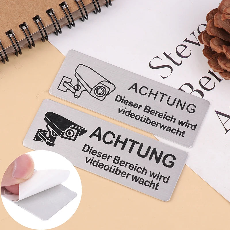 panneau signalétique argenté achtung surveillance vidéo adhésif caméra texte avertissement graphique simple porte