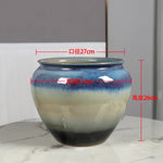 Pot de fleurs en céramique de forme ronde avec un motif de dégradé bleu et blanc, mesurant 27 cm de diamètre et 26 cm de hauteur.