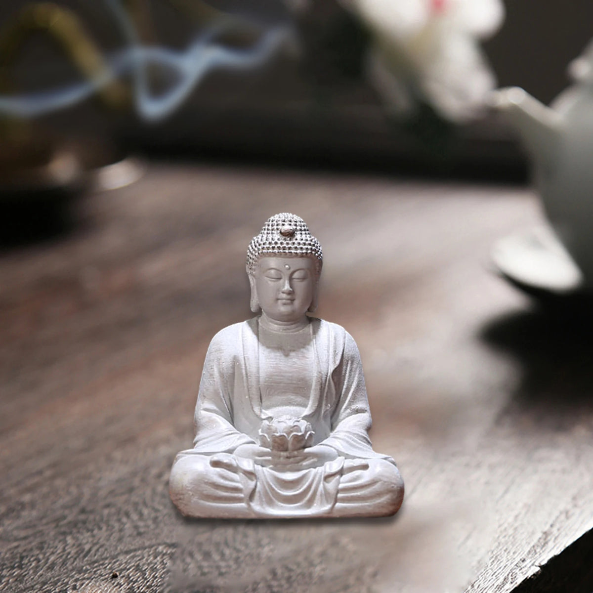 statue bouddha zen blanc gris bois décoratif assiette cigarettes tapis fibres naturellements éléments divers