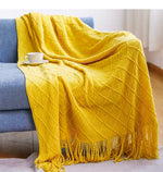 couverture tricotée vert foncé motif zigzag pompons canapé lit décoration intérieure moderne large
