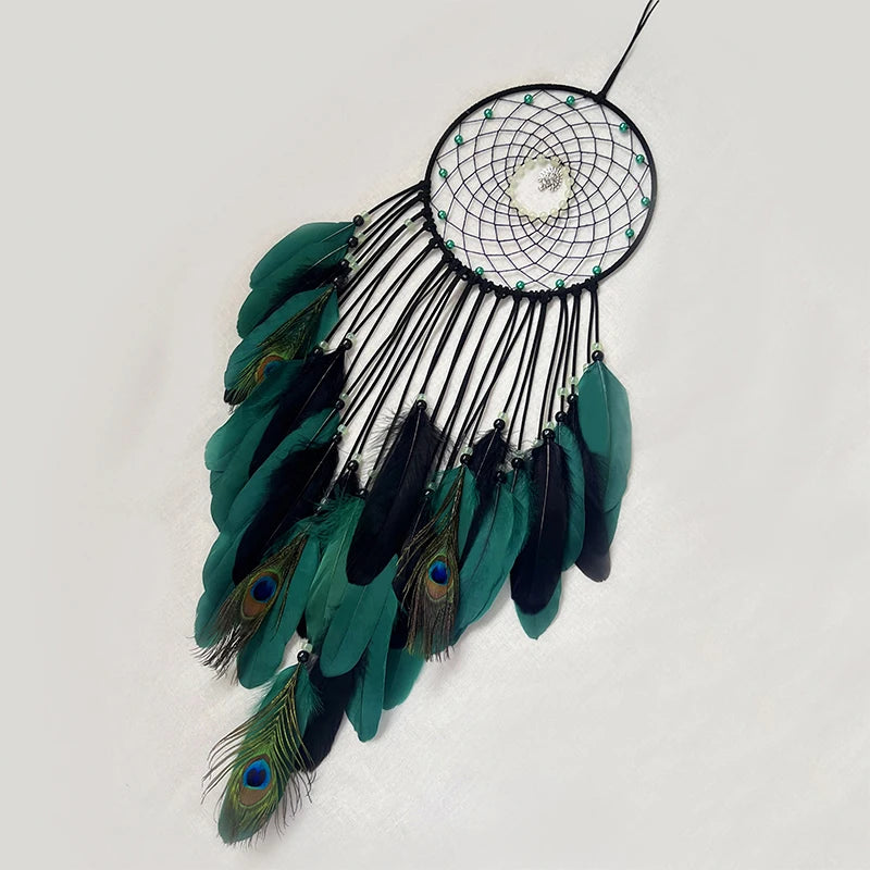 Un magnifique attrape-rêves circulaire garni de plumes de paon vert foncé et de plumes noires, formant une belle composition décorative.