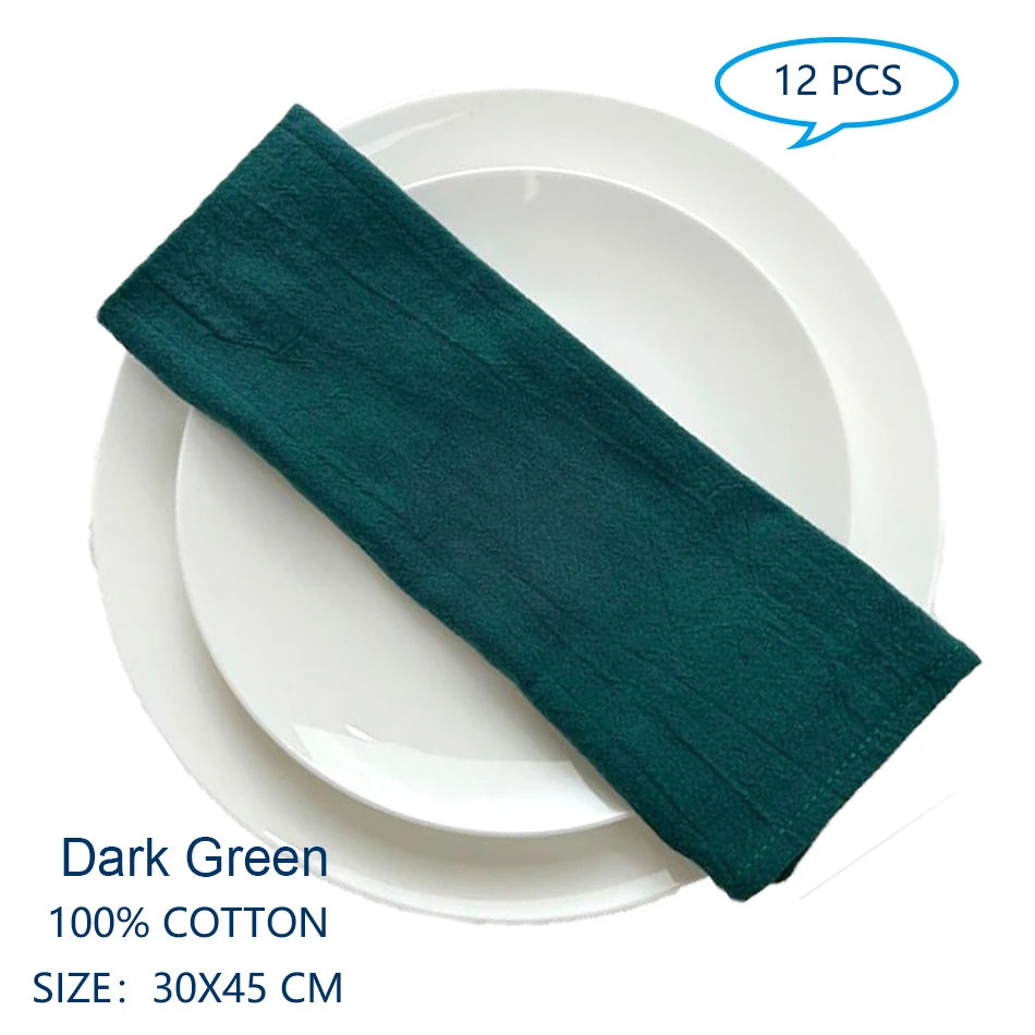 Des serviettes de table en coton de couleur vert foncé, de dimensions 30 x 45 cm, vendues par lot de 12 pièces.