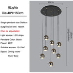 suspension lumineuse contemporaine noir doré sphères métalliques brillantes éclairage intérieur maison