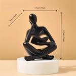 figurine deco moderne or noir blanc personne assise livre socle chambre abstraction minimalisme