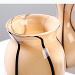 vases modernes translucides opaques motifs tourbillonnaires branches fleurs artificielles marron orange beige