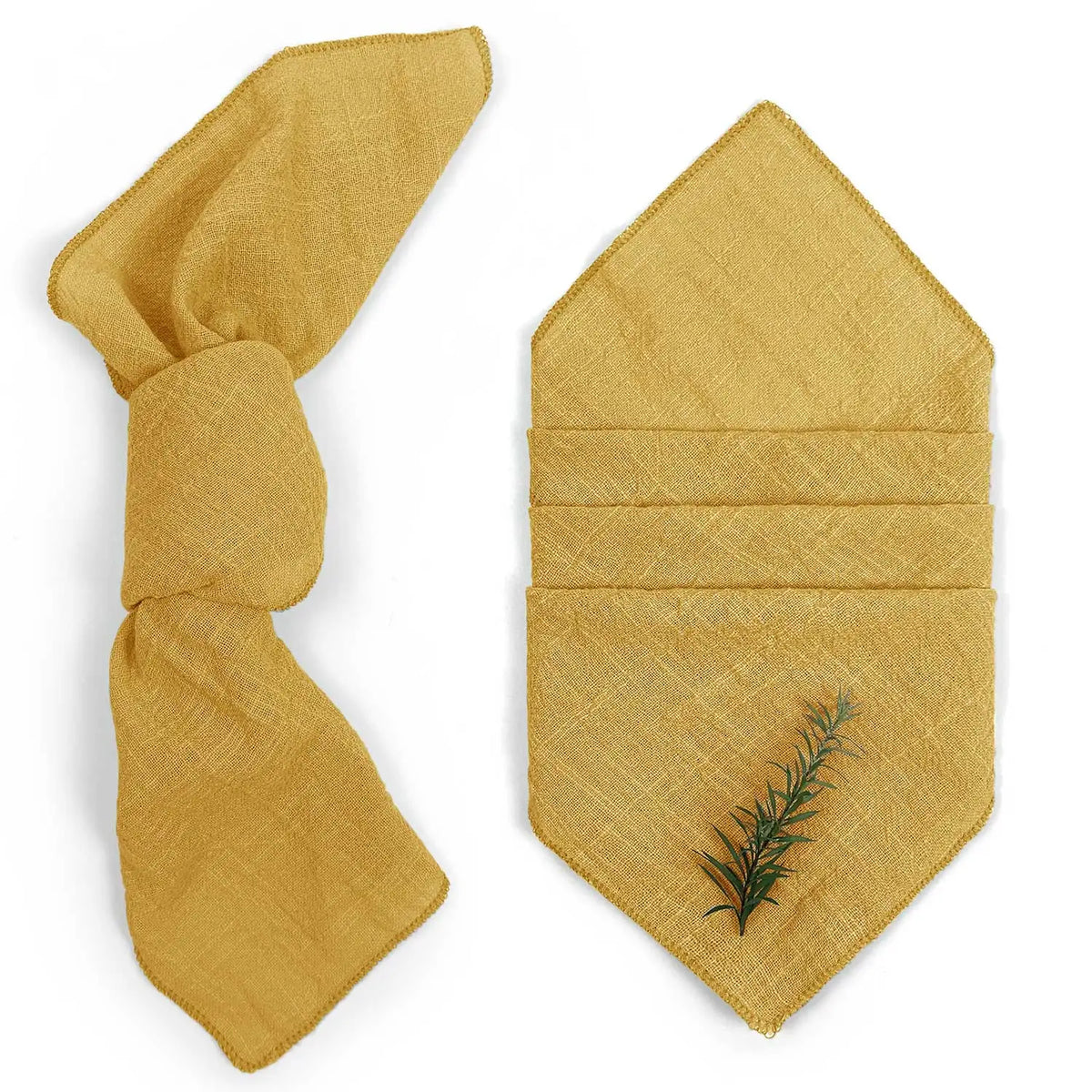 Des serviettes de table pliées, teinte ocre avec un motif de brindille.