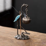 statuette oiseau or noir bleu artisanal élégant décoration maison motif floral support métal