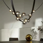 Suspension lumineuse contemporaine boules translucides structure métallique noir marron doré minimaliste