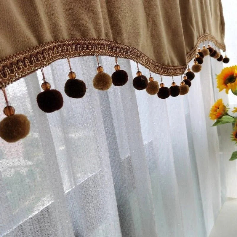 Cantonnière élégante avec pompons décoratifs suspendus, idéale pour embellir les fenêtres de votre salon ou chambre à coucher. Design sophistiqué alliant confort et style, parfaite pour créer une ambiance chaleureuse et accueillante. Finition minutieuse et attention aux détails pour un intérieur raffiné.