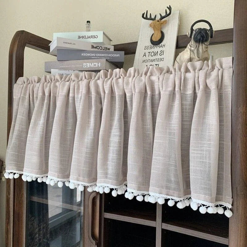 Rideau de cuisine élégant avec pompons décoratifs, idéal pour apporter une touche de charme à votre intérieur. Ce petit rideau beige ajoute une ambiance chaleureuse à n'importe quelle pièce tout en offrant une protection contre la lumière excessive. Parfait pour les fenêtres de cuisine ou de salle de bain, ce rideau s'adapte facilement à différents styles de décoration. Découvrez ce modèle de tenture stylisé pour embellir vos espaces de vie.