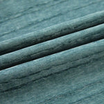Image montrant un tissu bleu texturé, plissé, idéal pour la décoration intérieure, la couture et l'ameublement. Parfait pour créer une ambiance élégante et moderne dans n'importe quelle pièce. Disponibilité en plusieurs couleurs pour s'adapter à tous vos projets créatifs.