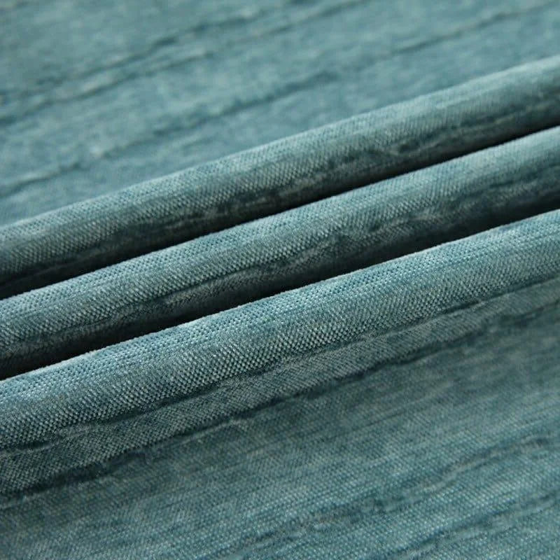 Image montrant un tissu bleu texturé, plissé, idéal pour la décoration intérieure, la couture et l'ameublement. Parfait pour créer une ambiance élégante et moderne dans n'importe quelle pièce. Disponibilité en plusieurs couleurs pour s'adapter à tous vos projets créatifs.