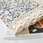 Nappe élégante avec motifs décoratifs bleus et bordure en dentelle, idéale pour rehausser la décoration de votre table. Parfaite pour ajouter une touche de sophistication et de charme vintage à vos repas et réceptions.