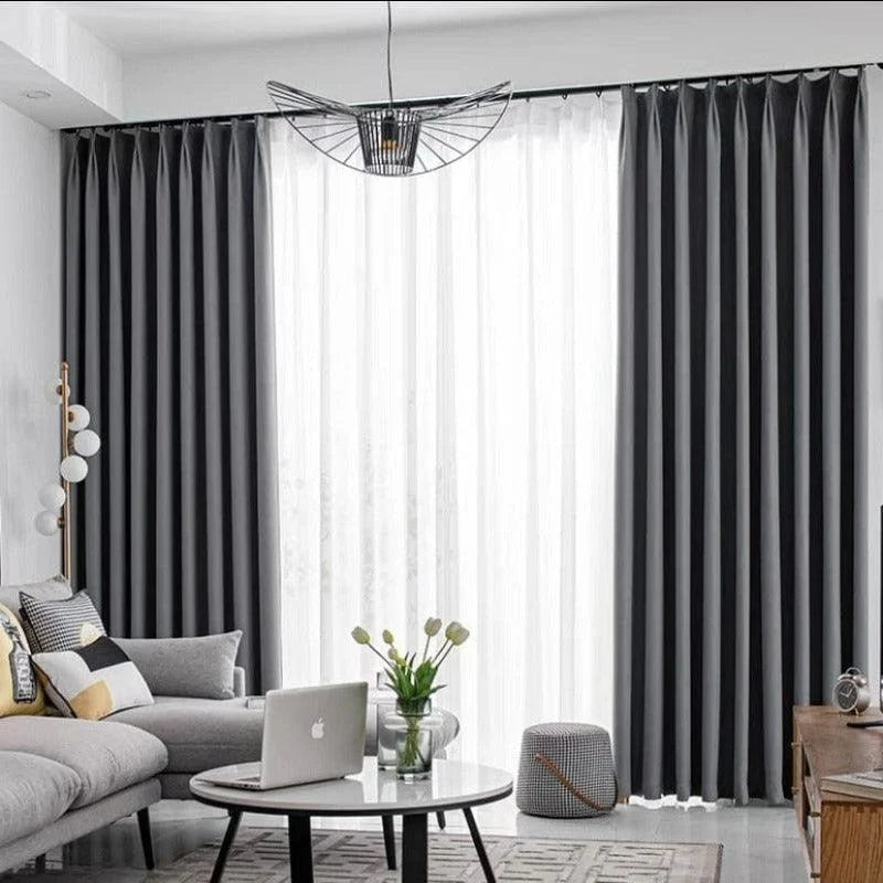 Rideaux élégants pour salon moderne, harmonie parfaite avec un canapé gris et des accessoires décoratifs contemporains, offrant une ambiance chic et raffinée. Luminosité douce idéale pour l'intérieur.
